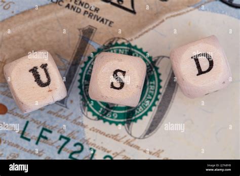 Usd Word Written On Wooden Blocks On 100 Dollar Banknote Background For