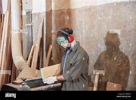 Carpenter processing wood with competence Stock Photo - Alamy