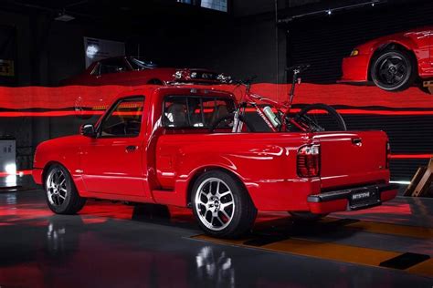 A Red Pick Up Truck Parked In A Garage