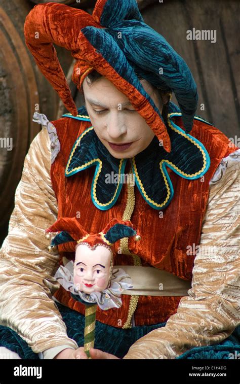 Sad Jester Sitting In Front Of Barrels Stock Photo Alamy