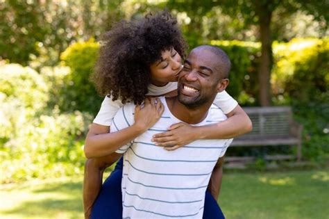 Premium Photo Happy Young Couple Holding Each Other In The Garden