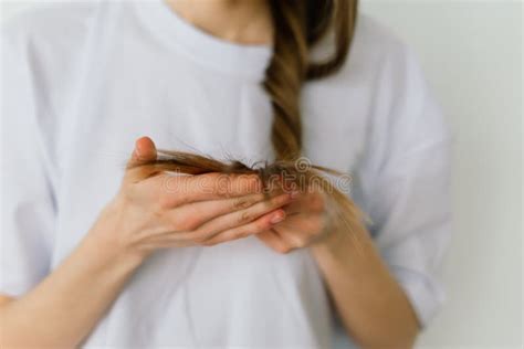 Girl Touching Her Hair And Smiling While Posing At Interior Looking In