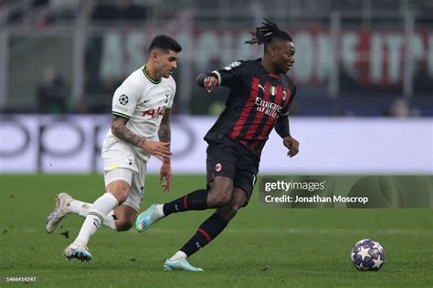 Rafael Leao of AC Milan is pursued by Cristian Romero of Tottenham ...