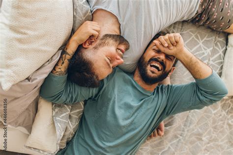 Happy Gay Couple Lying Down On The Bed At Home Hugging And Flirting Stock Photo Adobe Stock