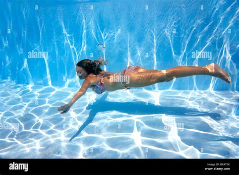 Girl In Bikini Swimming Underwater In Blue Pool Stock Photo Alamy