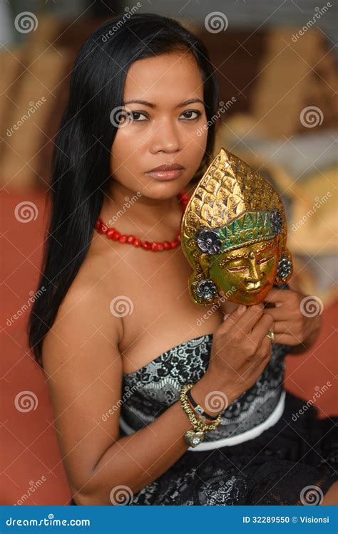 Beautiful Asian Brunette Model With Traditional Mask From Bali Stock