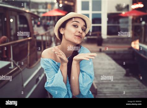 Portrait Of Beautiful Smiling White Caucasian Brunette Girl On Boat Yacht Pier Quay In Blue