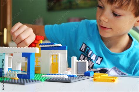 Boy Builds A House With Building Blocks Stock Photo Adobe Stock