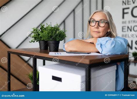 Portrait Of A Contented And Thoughtful Middle Aged Older Business Woman