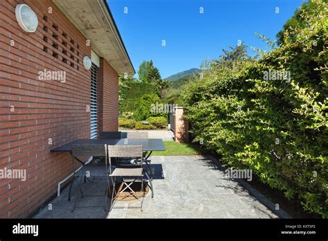 Patio of a modern brick house, outdoors Stock Photo - Alamy