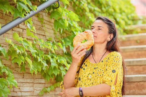 Attractive Brunette Woman Sitting On Stairs With Bagel Stock Image Image Of Portrait Smile