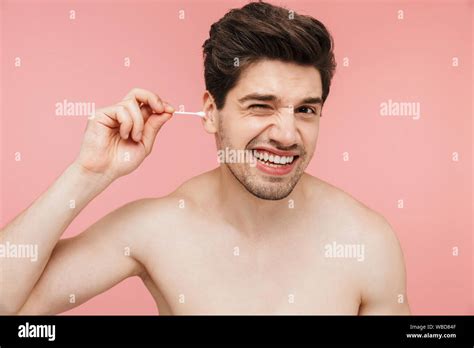 Beauty Portrait Of A Handsome Smiling Shirtless Brunette Man Standing Isolated Over Pink