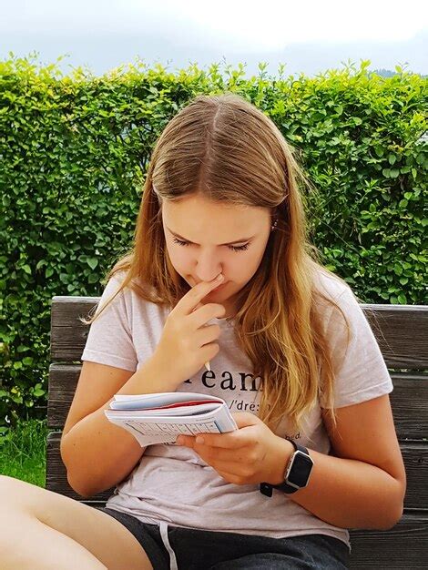 Premium Photo Woman Reading Book While Sitting Against Tree In Park