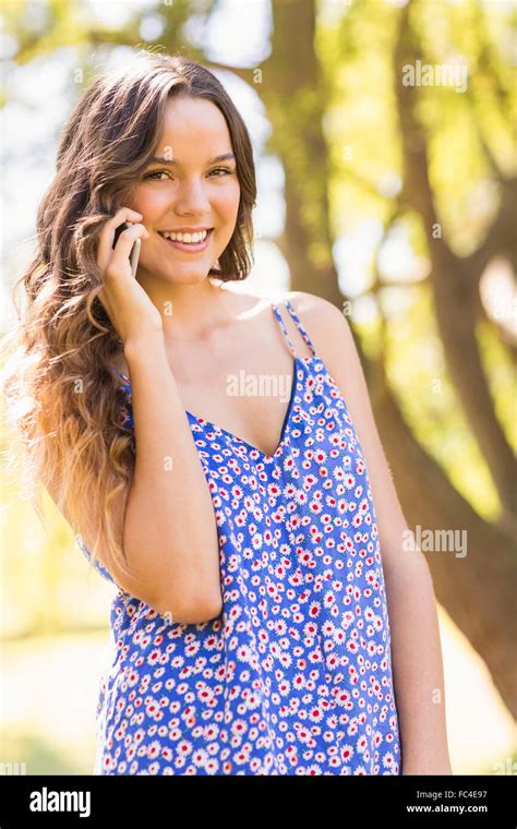 Pretty Brunette Having Phone Call In The Park Stock Photo Alamy