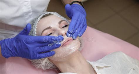 Close Up Of Young Confident Female Doctor Cosmetologist Wering White