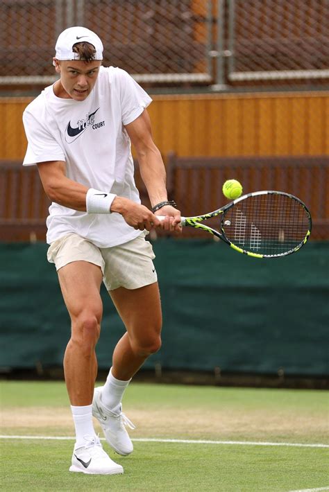 A Man Hitting A Tennis Ball With A Racquet