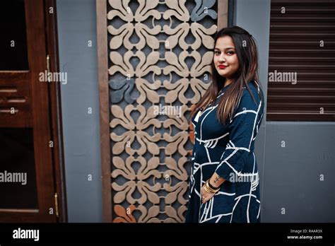 Brunette Indian Woman In Long Fashionable Dress Posed Outdoor Stock Photo Alamy