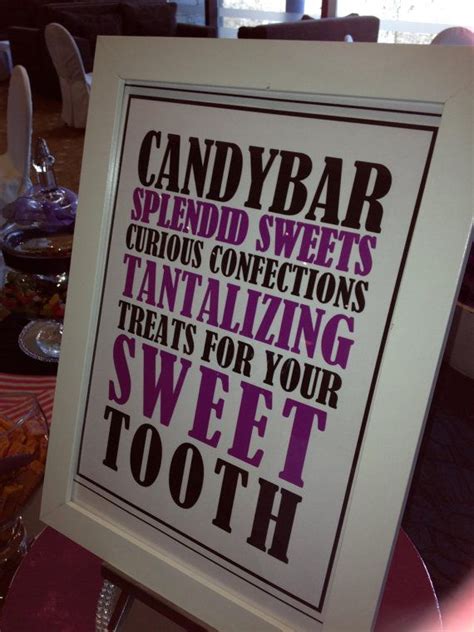 a candy bar sign is displayed on a table