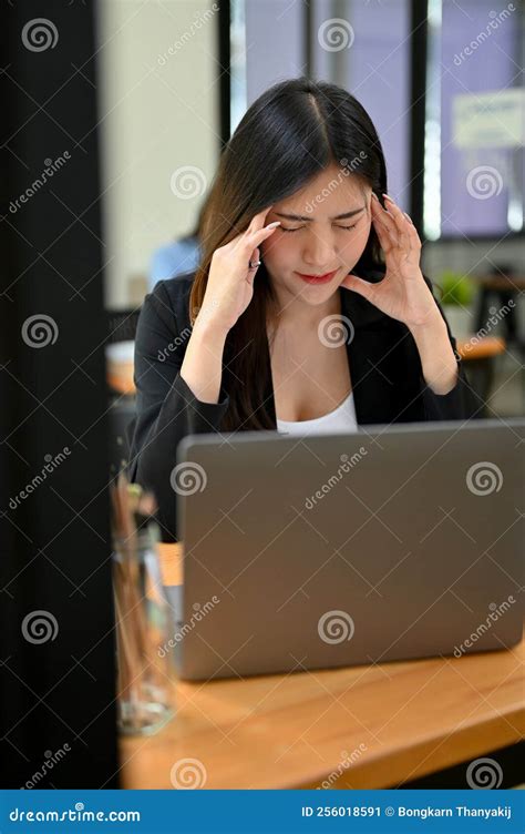 Portrait Stressed And Exhausted Young Asian Businesswoman Sitting At