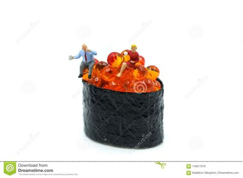 Miniature People Businessman Sitting With Salmon Egg On Sushi Stock