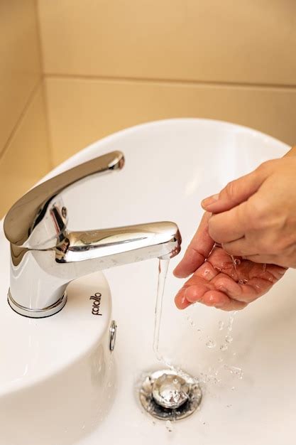 Premium Photo A Woman Washes Her Hands In The Bath