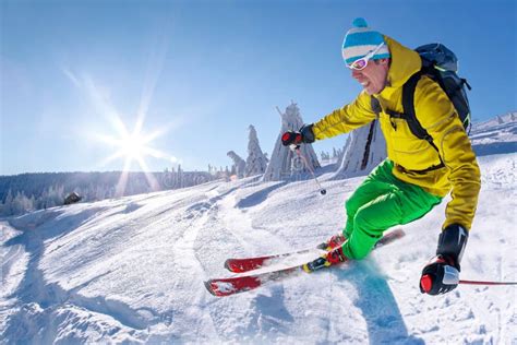 Skier Skiing Downhill In High Mountains Against Cable Lift Stock Image