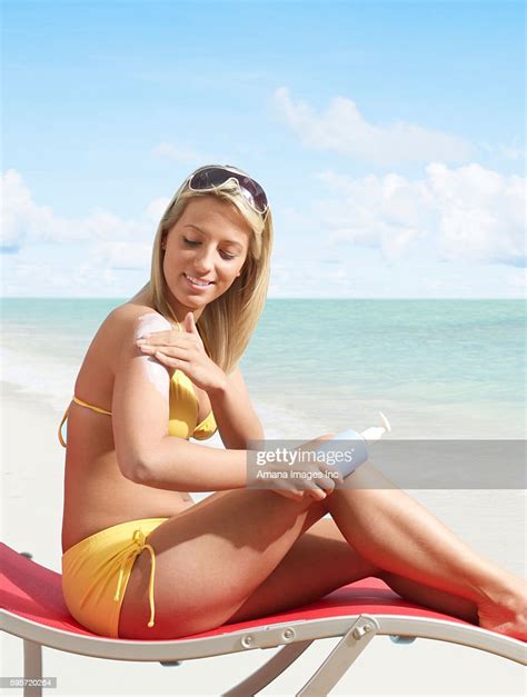 Woman Applying Sun Screen High Res Stock Photo Getty Images