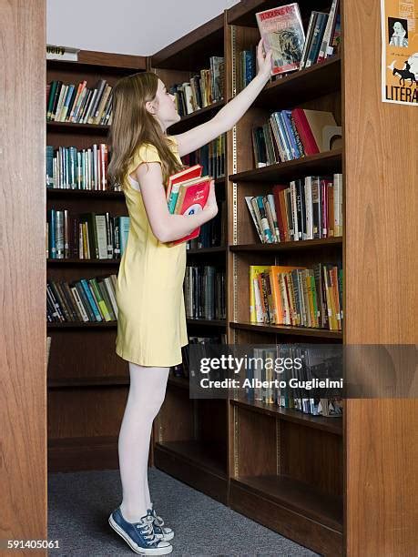 344 Woman Reaching Book From Shelf Stock Photos High Res Pictures And