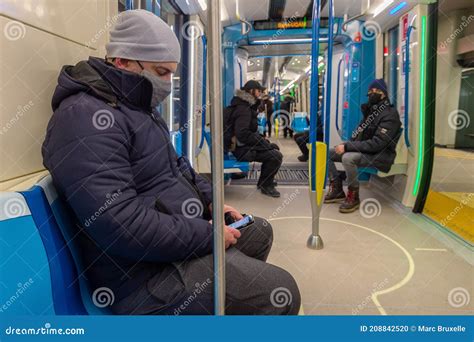 Passenger Sitting In Subway Train Wearing Face Mask To Protect From