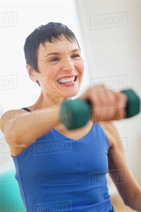 Mature Woman Exercising In Gym Stock Photo Dissolve