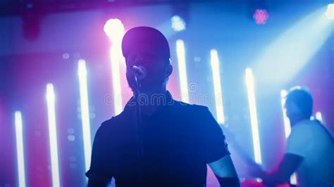 Rock Band Performing at a Concert in a Night Club. Portrait of a Lead ...