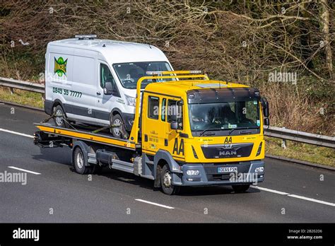 Aa Van Yellow Recovery Truck Carrying Broken Down Van Side View Of Man