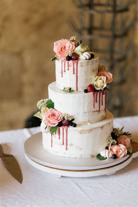 Semi Naked Wedding Cake With Flowers And Dripping Icing