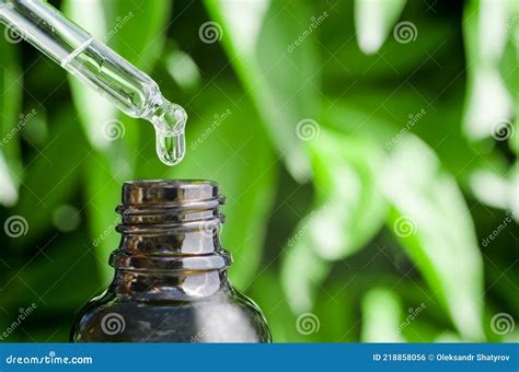 Close Up Of A Pipette Dripping Into A Bottle Dropper With Hyaluronic