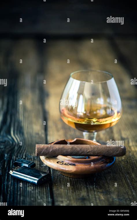 Hand Rolled Cuban Cigar And Glass Of Rum Or Cognac Stock Photo Alamy