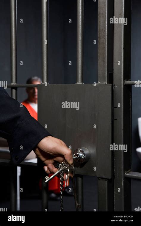 A prison guard locking a prison cell door Stock Photo - Alamy