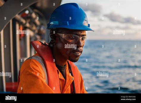 Tired Seaman Ab Or Bosun On Deck Of Vessel Or Ship Wearing Ppe Personal Protective Equipment