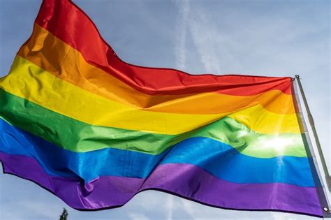 Premium Photo Rainbow Flag Lgbt Movement On The Sunny Blue Sky Background Colorful Gay Flag Waving