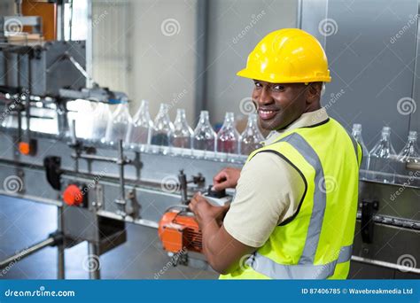 Smiling Factory Worker Operating Machine In Factory Stock Image Image