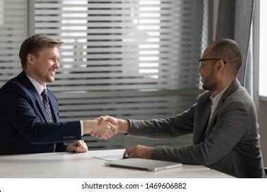 Two Businessmen Shaking Hands Workplace Client Stock Photo