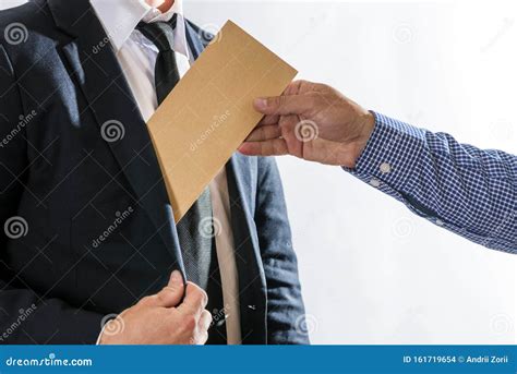 A Man Giving Bribe Money In A Brown Envelope To Another Businessman In