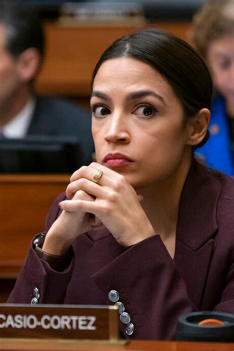 Download Alexandria Ocasio Cortez With Hands Intertwined Wallpaper