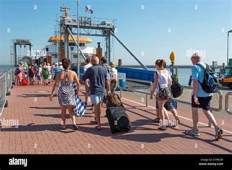 Ferry dock, passengers enter the ferryboat, island Langeoog, East ...