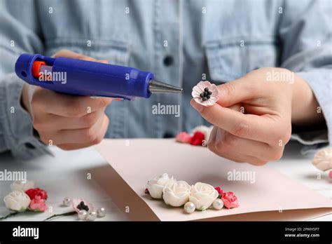Woman Using Hot Glue Gun To Make Craft At White Table Closeup Stock Photo Alamy