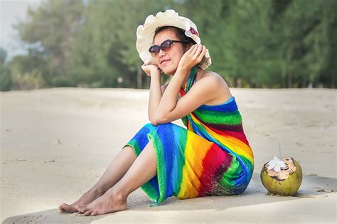 Royalty Free Photo Woman Sitting On Beach Sand Wearing Brown Sun Hat