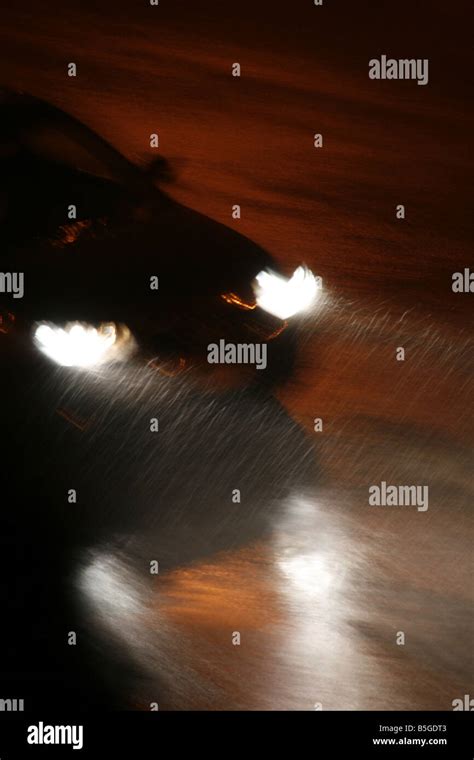 fast car driving in heavy rain at night in town Stock Photo - Alamy