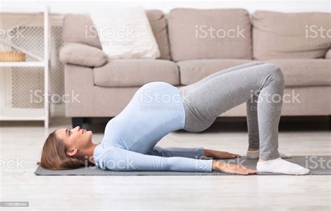 Full Length Image Of Pregnant Girl Doing Stretching Exercise Stock