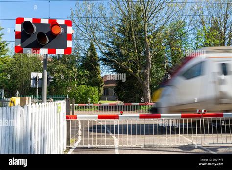 Railway Level Crossing With Gates Down In Rural Area Church Lane