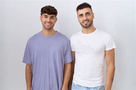 Homosexual Gay Couple Standing Over White Background With A Happy And Cool Smile On Face Stock