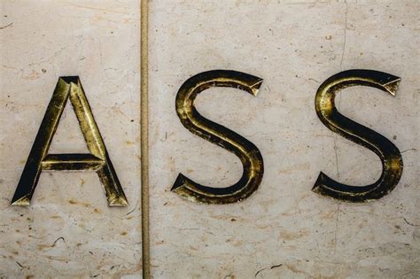 Premium Photo Close Up Of Ass Text On Wall
